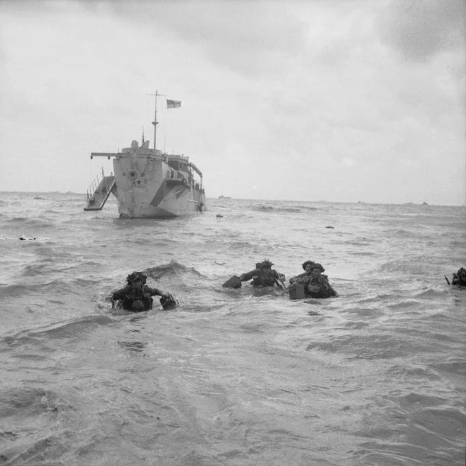 British troops wade ashore from an LCI(L) (Landing Craft Infantry -Large) on Queen beach in Normandy, Sword area, 6 June 1944.