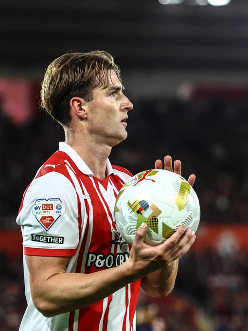 James Bree prepares to take a throw in during the semi-final win over Middlesbrough, wearing the red and white striped home shirt.