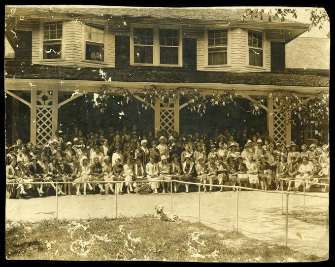 From the Mississippi Federation of Women's Clubs Collection. Annual convention photo at house with dalmatian and man in window.