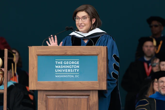 Commencement speaker Rebecca Kutler standing at the podium and speaking during the George Washington University Commencement.