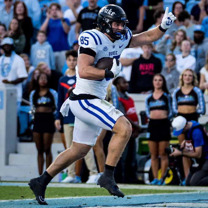 Duke tight end Jeremiah Hasley runs into the end zone and celebrates with his index finger raised during the Blue Devils' victory at North Carolina in 2025.
