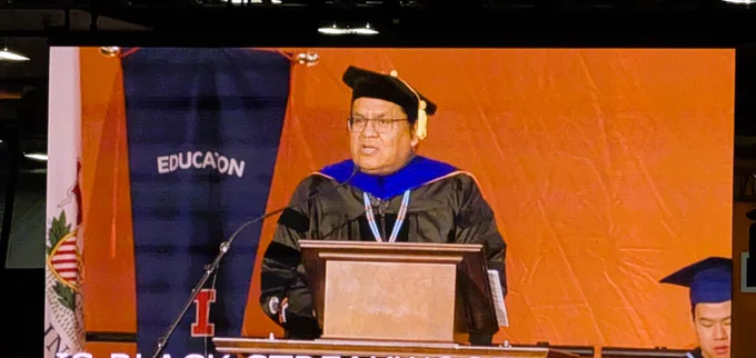 Dr. Oliver Tapaha speaking at the 2026 College of Education convocation ceremony at the Activities & Recreation Center in Champaign