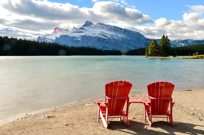 Red chair at two jack Lake in the Canadian Rockies  
