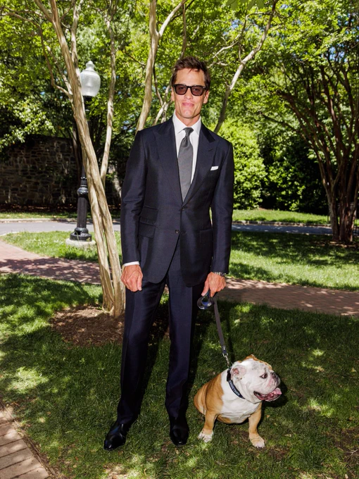 Tom Brady and Jack the Bulldog posing for the camera 

