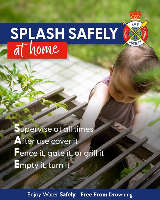 A person is interacting with water in a wooden trough outdoors. The image features the Royal Life Saving Society logo and promotes water safety at home. The acronym "SAFE" advises: Supervise, After use cover, Fence or gate, and Empty or turn. A tagline at the bottom reads, "Enjoy Water Safely | Free From Drowning.