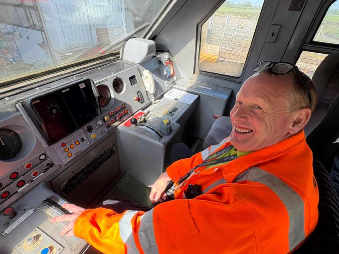 Rail Adventure driver Ian Piper sitting in cab of a train.