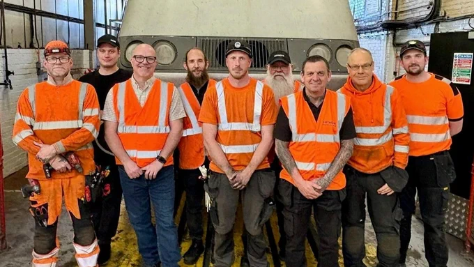 Class 43 fitment team smiling in front of a train.