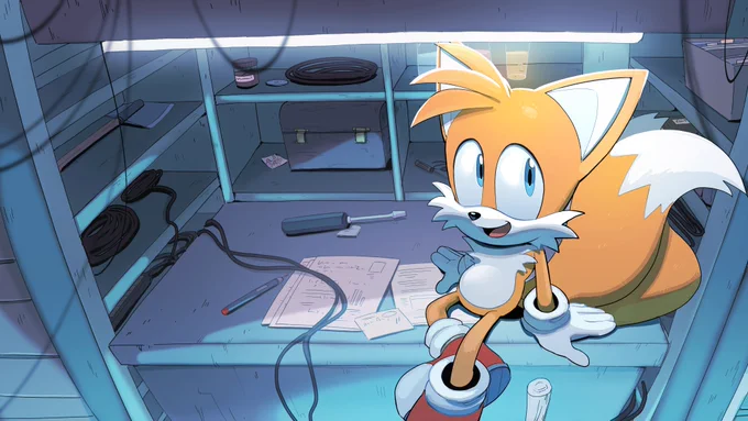Tails sitting in a lab/garage looking up at the viewer