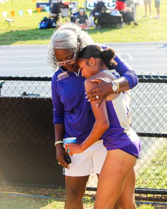 Director Delethea Quarles hugging Sky Bleu Tyson following Tyson completing the 400-meter hurdles.