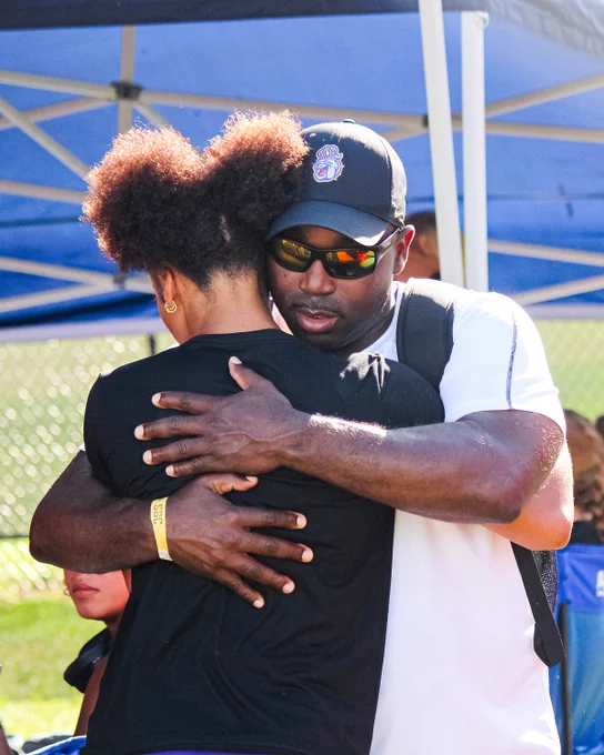 Head Coach Pete McFadden hugging Mykenzie Britton.