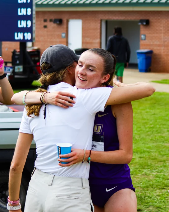 Coach Rebekah Ricksecker hugging Carole-Anne Garrett after Garrett ran the 1,500 meters.