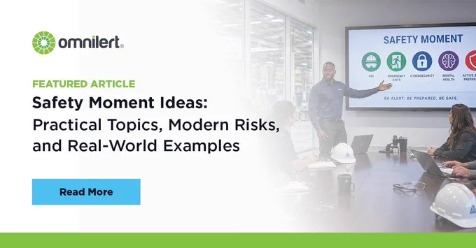 A graphic. The left half is white and fades into an image of a manager giving a safety moment talk to his employees. On the white half, in small green text it says "Featured Article," and below it, in larger black font "Safety Moment Ideas: Practical Topics, Modern Risks, and Real-World Examples." Above the text is the Omnilert logo, and below it is a non-clickable button that says "Read More."
