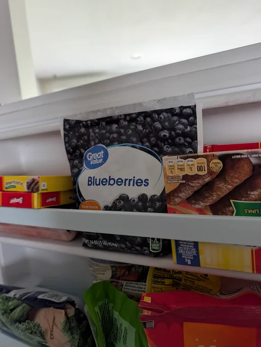 a feeezer door side with great value blueberries within.