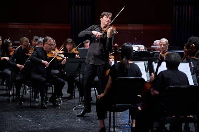 Violinst Joshua Bell taking center stage with his Stradivarius violin.