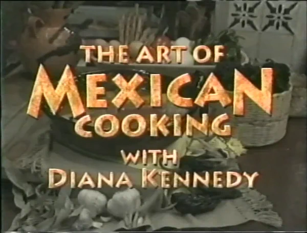 Cover of a book titled "The Art of Mexican Cooking with Diana Kennedy," featuring an assortment of vegetables and traditional ingredients in the background.