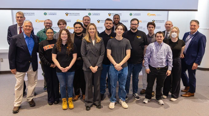 A group of individuals is posing for a photo at a Princeton University event. The backdrop features logos of Princeton University, Andlinger Center for Energy and the Environment, and Princeton Plasma Physics Laboratory.
