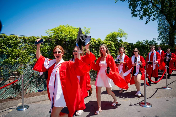 Photo of BU women's soccer graduates walking into Nickerson Field
