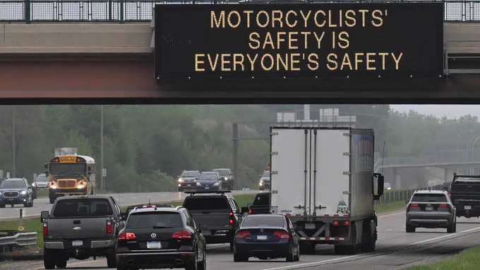 Electronic sign on highway above traffic. The sign reads, "Motorcyclists’ safety is everyone’s safety.”
