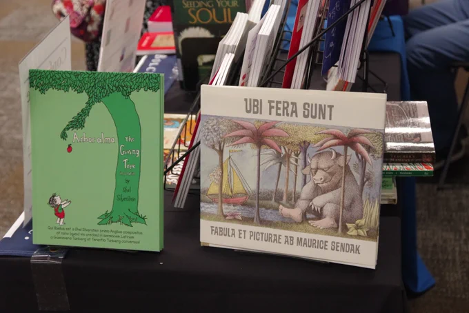 Photo of The Giving Tree and Where the Wild Things Are children's picture books translated into Latin at the Bolchazy-Carducci Publisher's booth at ICMS. Photo Credit: Michael Symonds, WMUK.