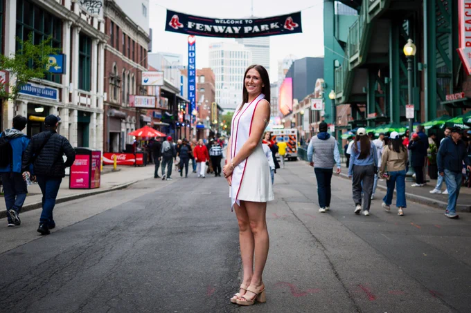 Photo of Audrey Ericksen posing for her graduation photo near Fenway Park