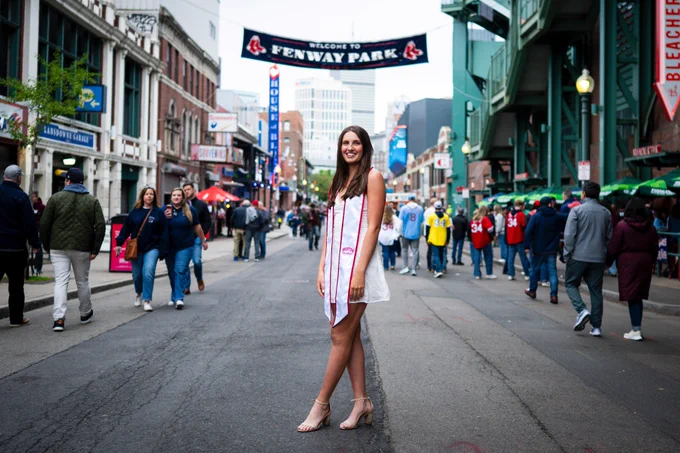 Photo of Aoibhe Gormley posing for her graduation photo near Fenway Park
