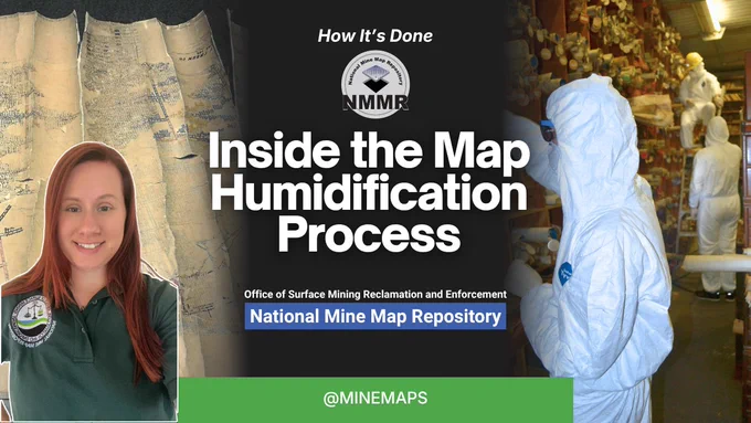 Person in green shirt stands beside old mining maps displayed on a wall in a National Mine Map Repository setting.