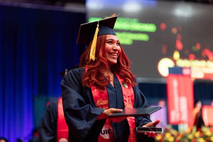 UIC grad smiles with diploma