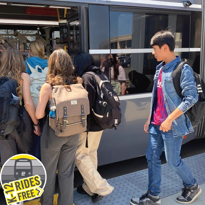 Photo of students boarding an ORBT bus at an ORBT station. Logo in bottom left reads, "K-12 rides free".