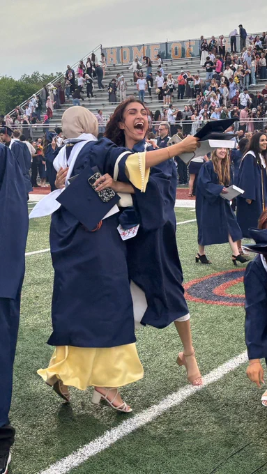 Two Stagg graduates embrace after the graduation ceremony..
