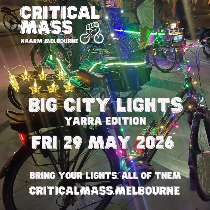 Photo taken at night near Melbourne Museum forecourt. Step through bike frame, front basket and handlebars adorned with strings of festive multi coloured lights.