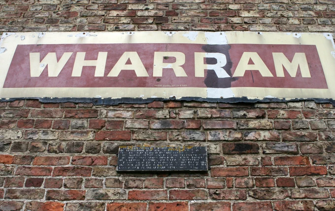 The sign reads "This sign formerly stood on the platform of Wharram Station (opened May 1853, closed to passengers 1950, fully closed 1958). It was removed by the British Railways and was in storage for several years. Following its restoration, it was donated to this site and unveiled on 11th May 1991, exactly 138 years after the opening of the line." Image Uncle Bucko CC BY-NC 2.0