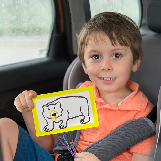 Boy holding up his Wikki Stix creation!
