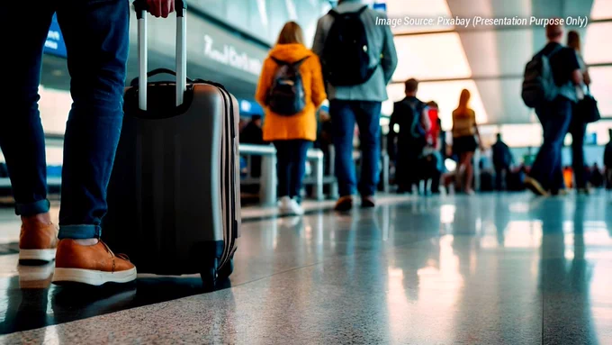 Travelers carrying cabin baggage and trolley luggage inside an airport terminal before boarding an IndiGo flight in India. The image represents airline cabin baggage rules, airport security preparation, hand baggage size limits, and travel planning for domestic and international passengers. A passenger stands with a cabin trolley bag while other travelers walk through the boarding area in the background. The image visually reflects common airport travel situations related to baggage weight limits, laptop bags, liquids, restricted items, and airline travel guidelines for Indian flyers in 2026. Ideal for articles discussing IndiGo cabin baggage rules, airport packing tips, and first-time flight preparation.
