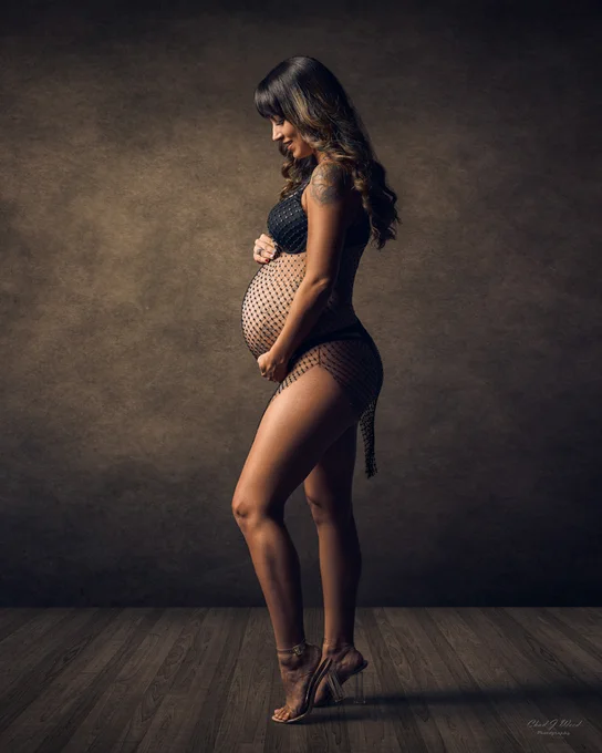 Fishnet dress and high heels in a mesa maternity photography photoshoot.