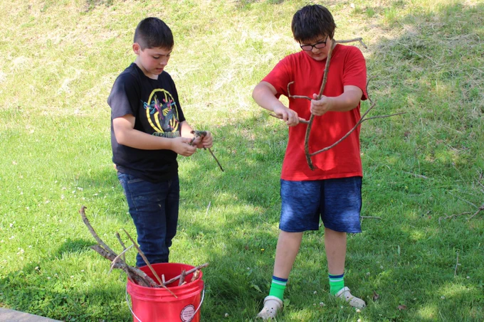 Students pick up old branches, leaves and weeds at Grand Vue's mini golf course.