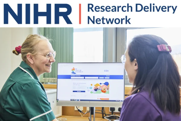 Image of two health professionals sat at a desk looking at the computer screen. The screen has an image of the NIHR website landing page on it. Logo above the image reads NIHR Research Delivery Network
