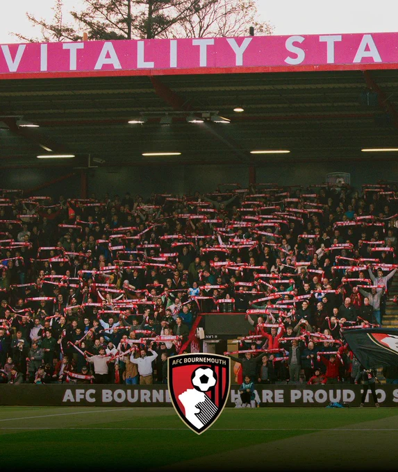 The Cherries supporters with their Minus 17 scarves aloft while Never Tear Us Apart plays.