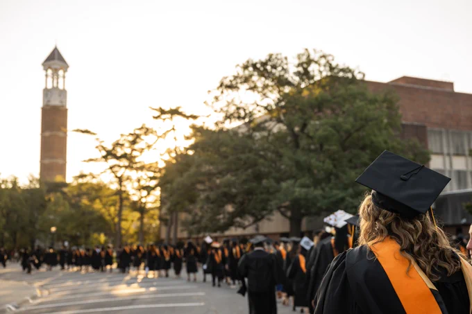 Purdue University tower in the background... graduates walking toward it