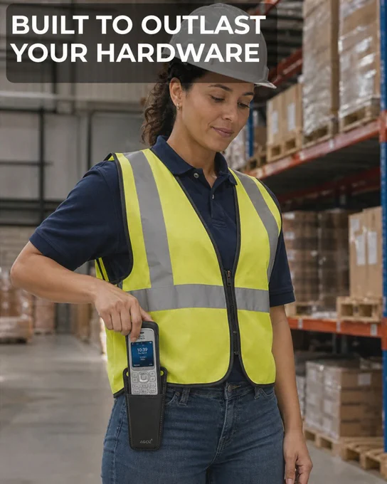 A warehouse worker in a hard hat and safety vest pulls a handheld device from a black protective belt holster in a warehouse aisle, with text reading “Built to Outlast Your Hardware.”