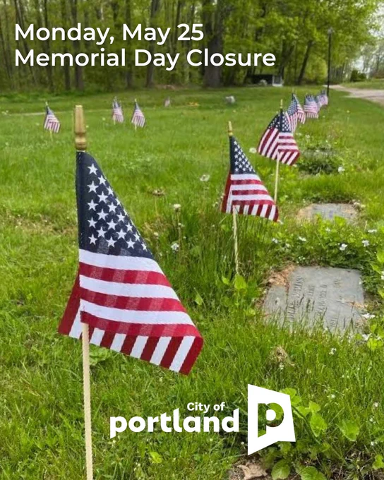 American flags placed on graves in Evergreen Cemetery with Memorial Day closure notice for Monday, May 25, from the City of Portland.
