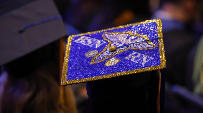 A decorated graduate cap with "BSN. RN."