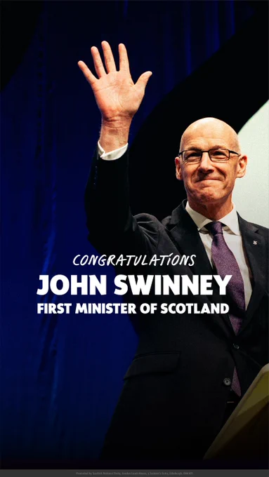 John Swinney raising his hand in a formal suit with congratulatory text for becoming Scotland's First Minister.