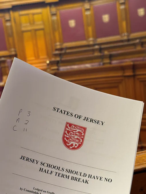 A paper proposition being held up in the States Chamber. 
