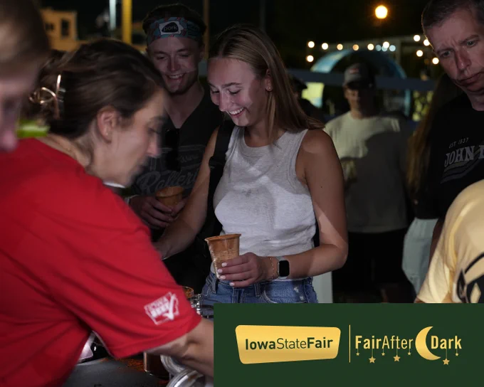 a group of people doing a fun experiment during a Fair After Dark in 2025. They appear to mixing sand. 