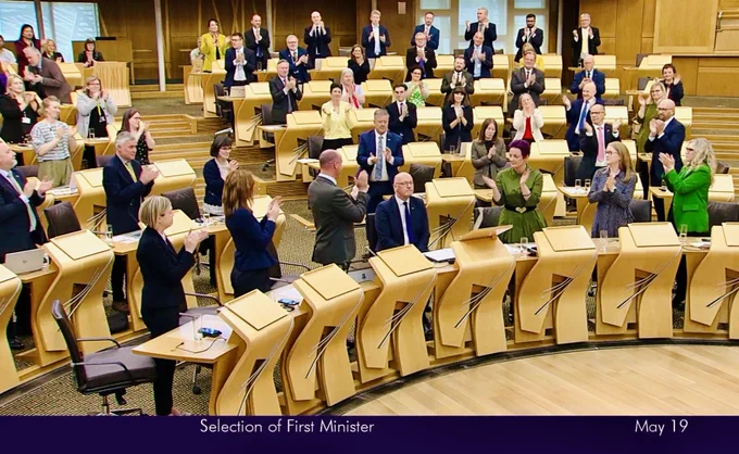 SNP MSPs at the Scottish Parliament give John Swinney a standing ovation