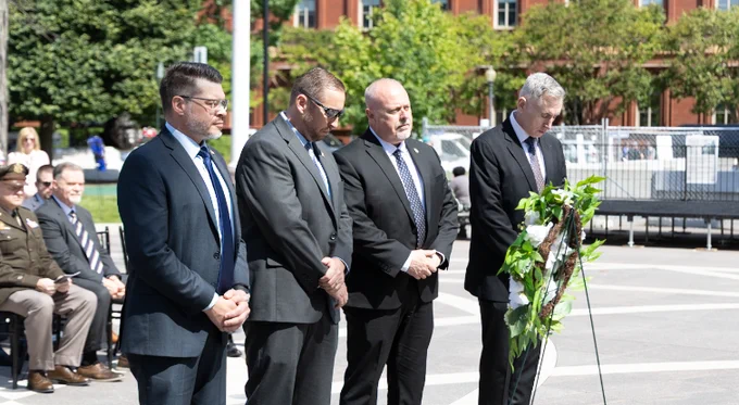 Director L. Scott Moreland stands with CID leaders as taps is played during the wreath laying ceremony.