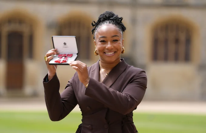 Sadia Kabeya holds her MBE at Windsor Castle.