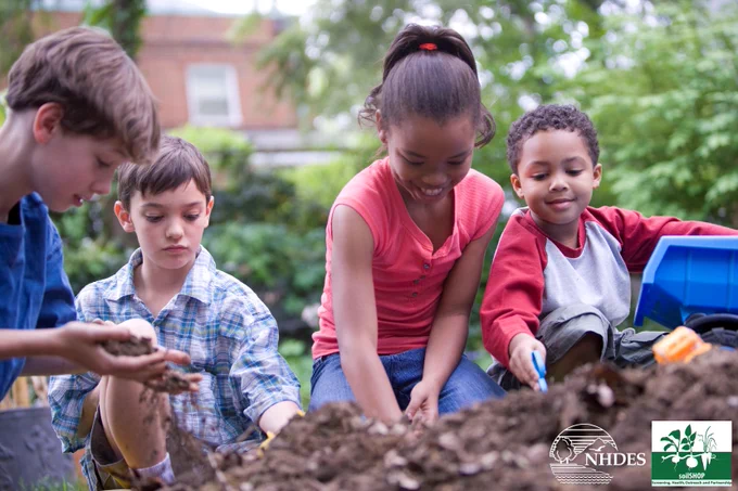 Children playing with toys in the dirt.