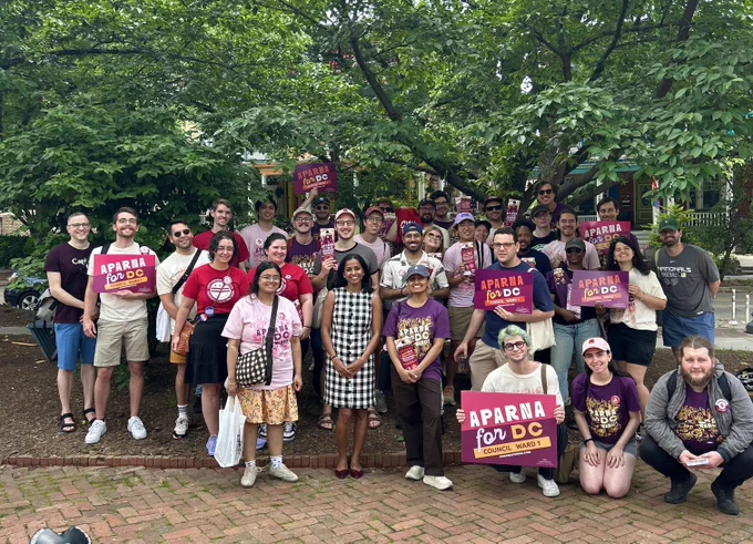 Group photo from a big canvass launch with Aparna and canvassers holding Aparna for DC signs