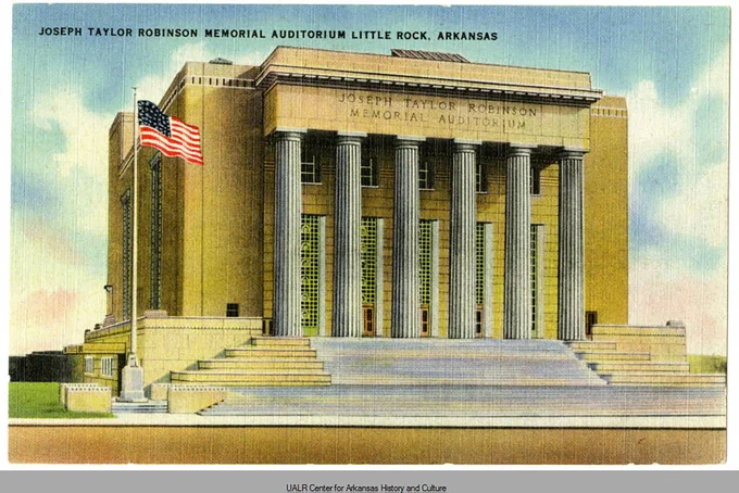 A postcard with the front view of Joseph Taylor Robinson Memorial Auditorium in Little Rock with tall columns and an American flag on a pole.